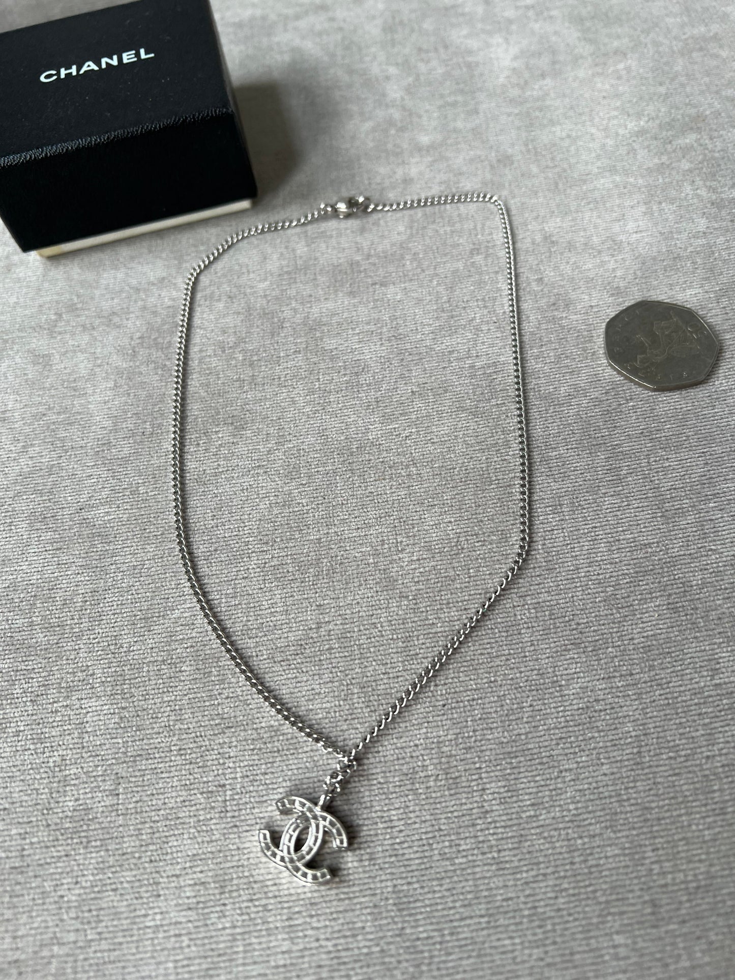 Chanel Silver Toned Embossed CC Pendant Necklace